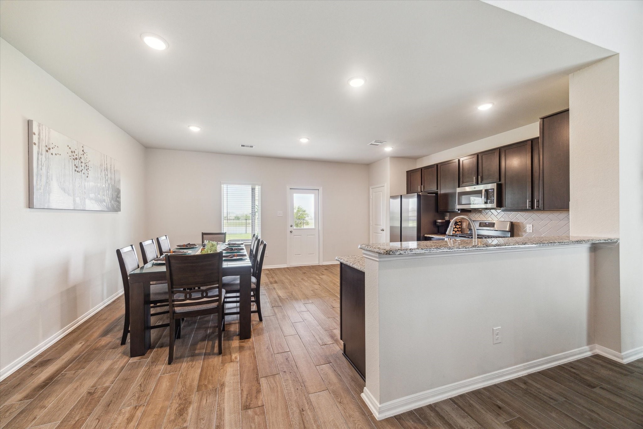 1523 Alpine Drive Rosharon, TX 77583 - Photo 11 of 25 a living room with stainless steel appliances wooden floor dining table and chairs