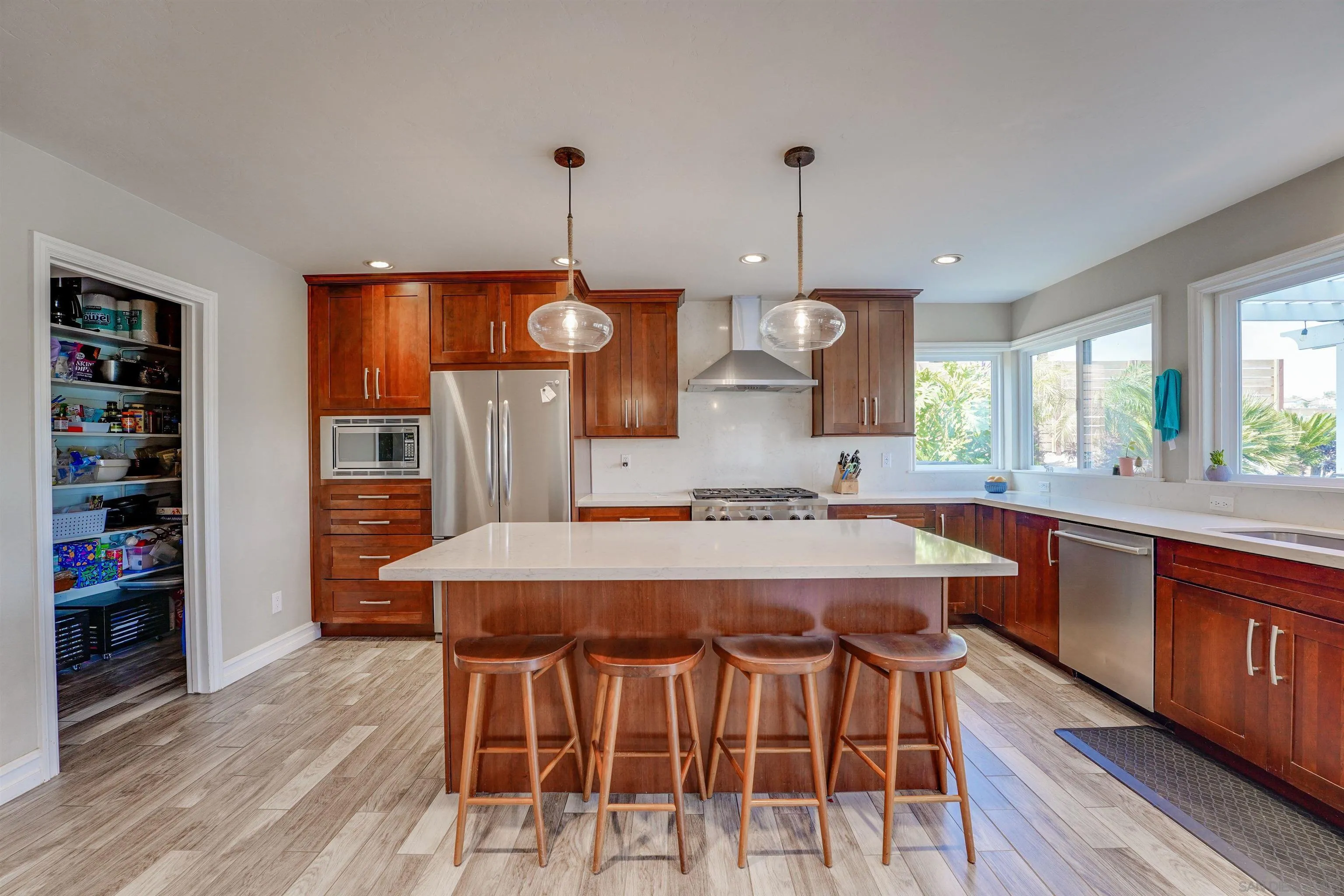 1647 Hawk View Drive Encinitas, CA 92024 - Photo 16 of 73 a large kitchen with a table and chairs