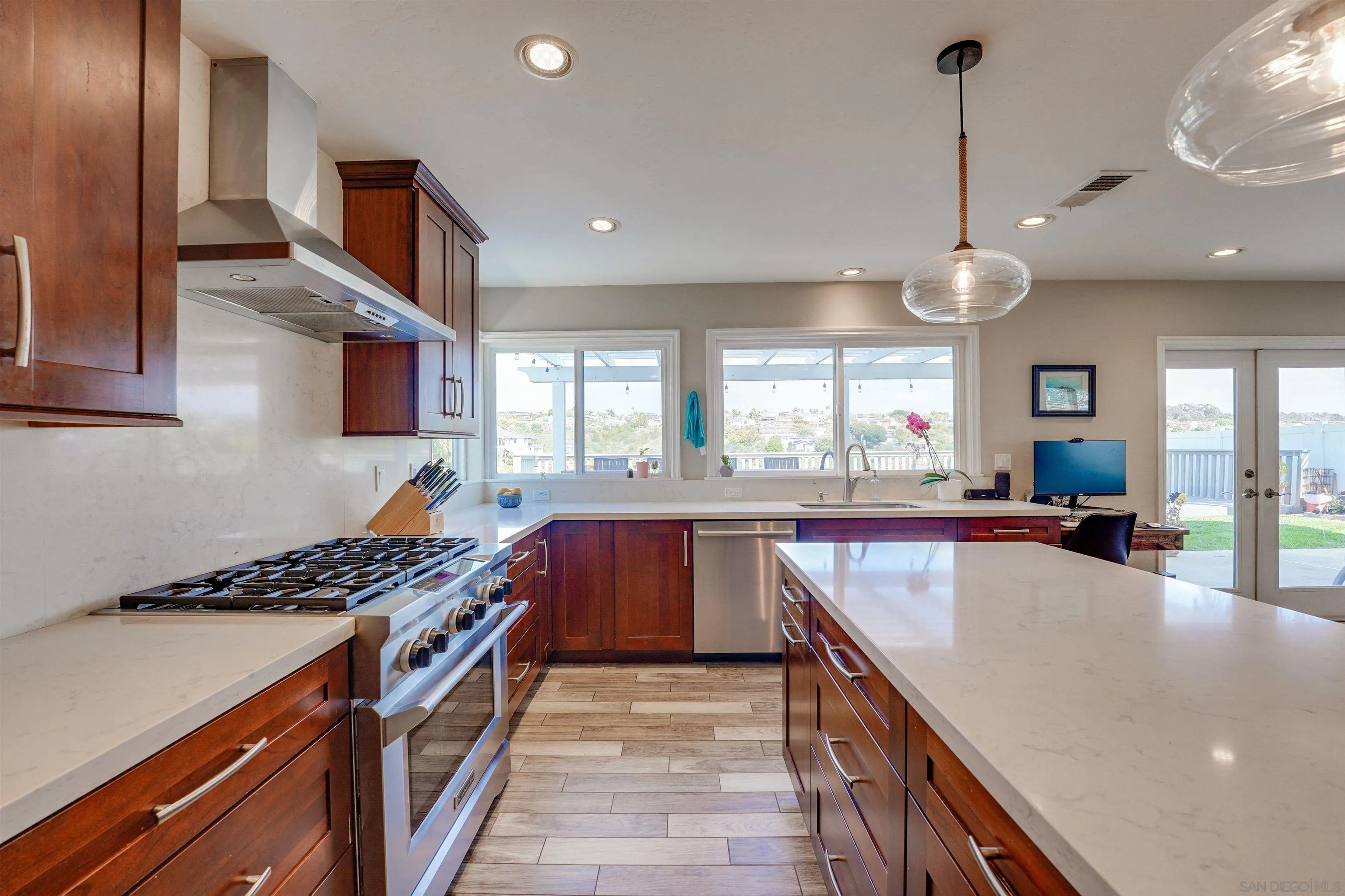 1647 Hawk View Drive Encinitas, CA 92024 - Photo 17 of 73 a kitchen with stainless steel appliances granite countertop a stove and a sink