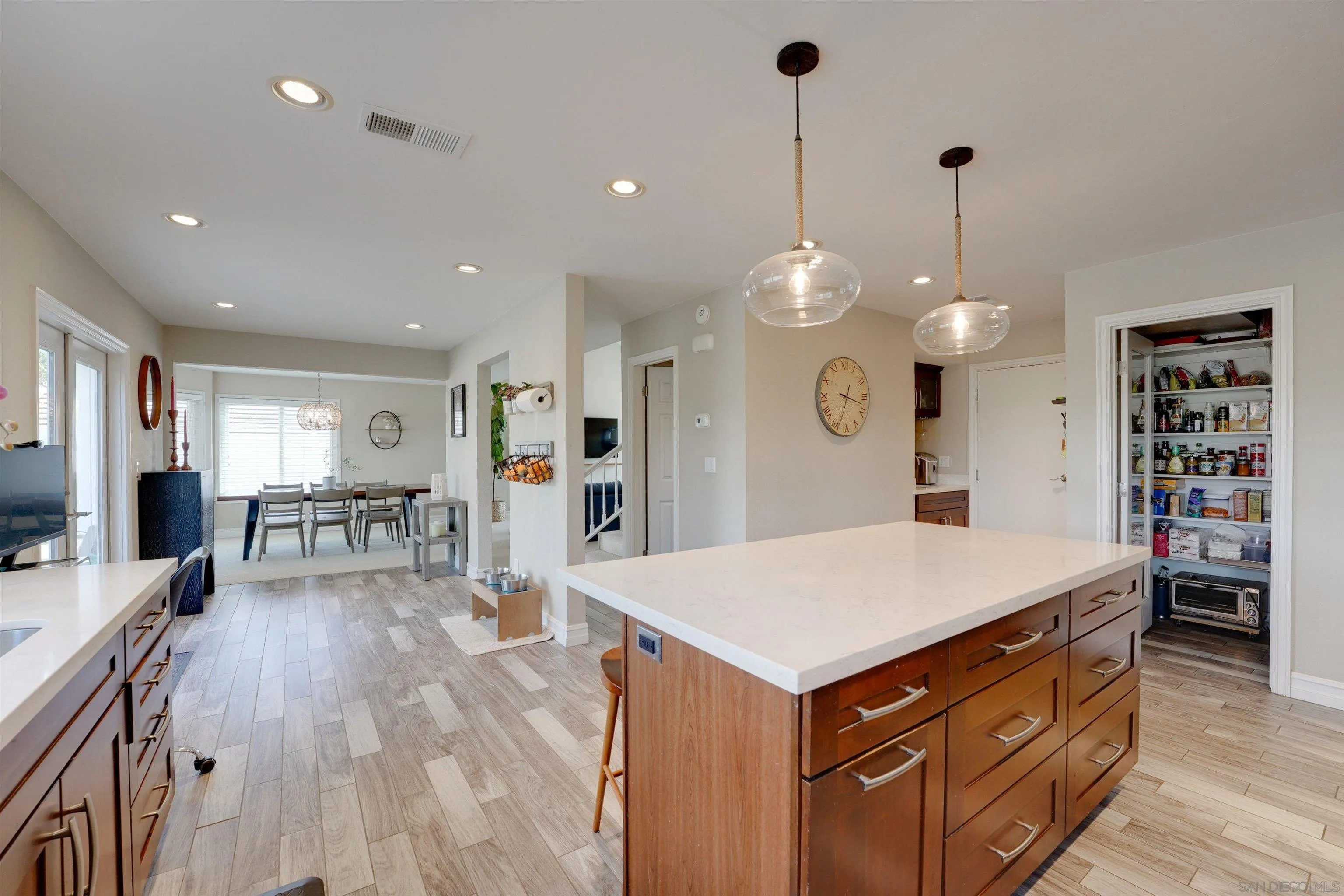 1647 Hawk View Drive Encinitas, CA 92024 - Photo 18 of 73 a large kitchen with stainless steel appliances a large center island attached withe living room