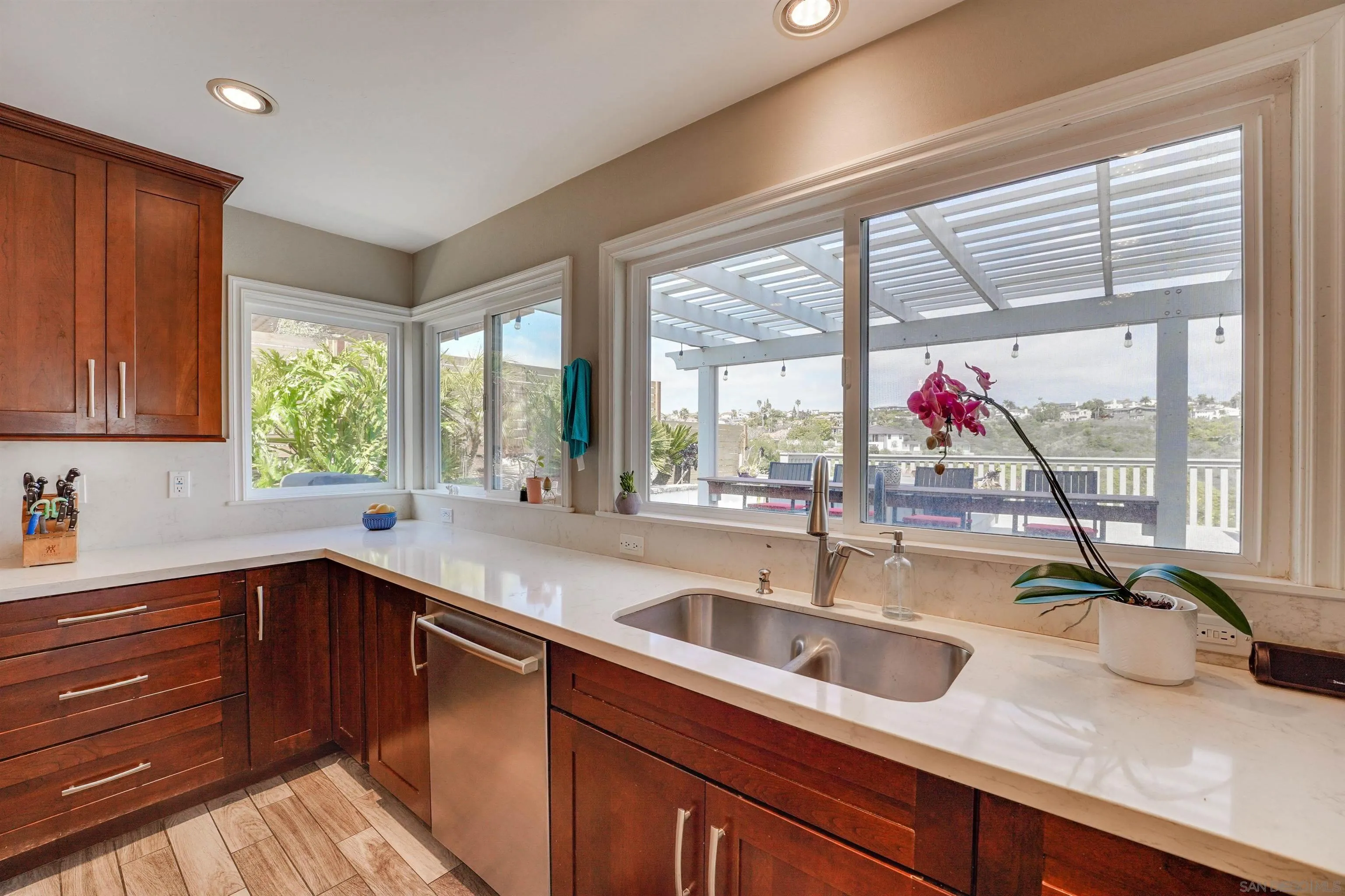 1647 Hawk View Drive Encinitas, CA 92024 - Photo 19 of 73 a kitchen with a sink a counter and a large window