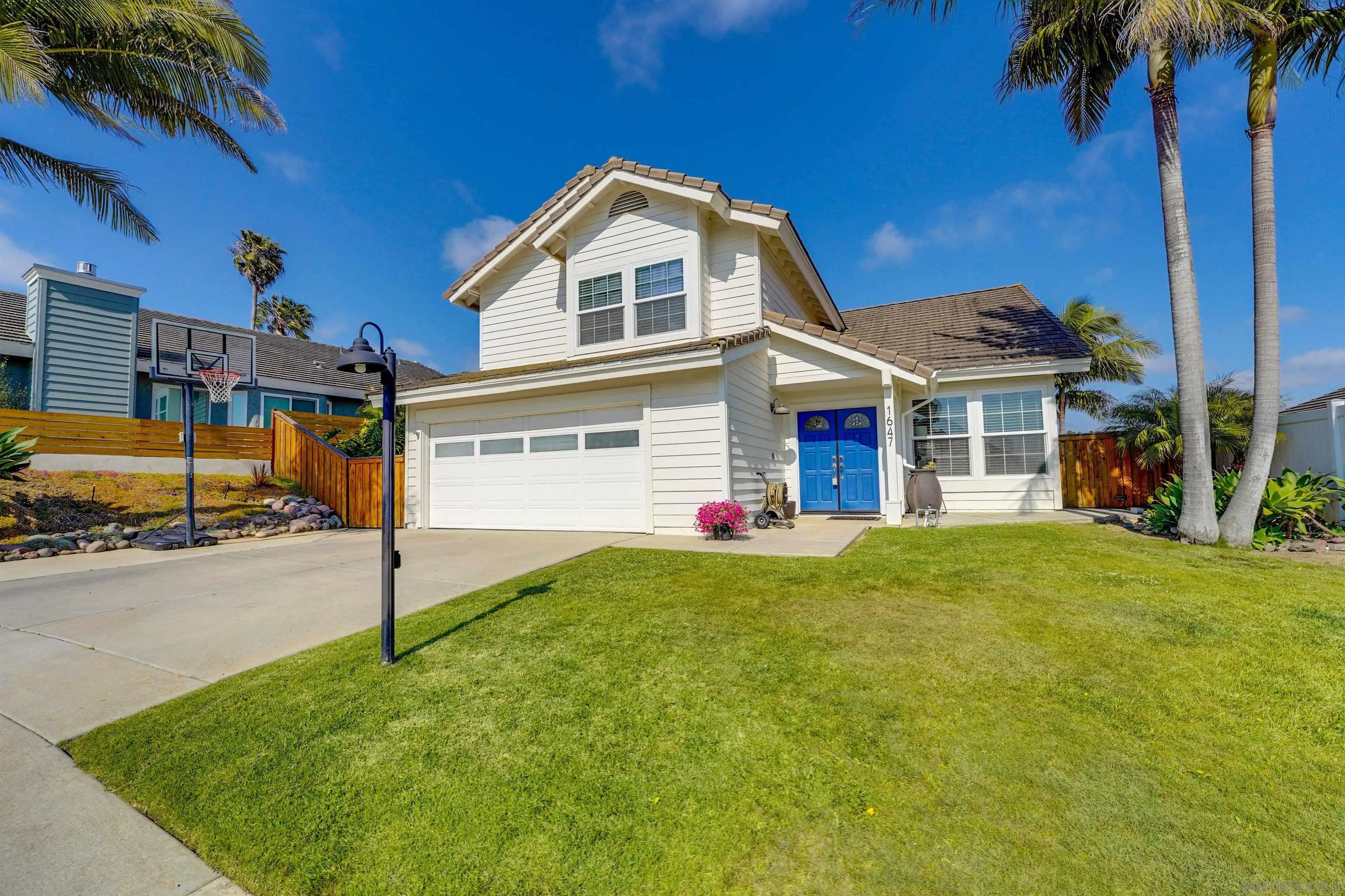 1647 Hawk View Drive Encinitas, CA 92024 - Photo 2 of 73 a front view of a house with a yard and garage