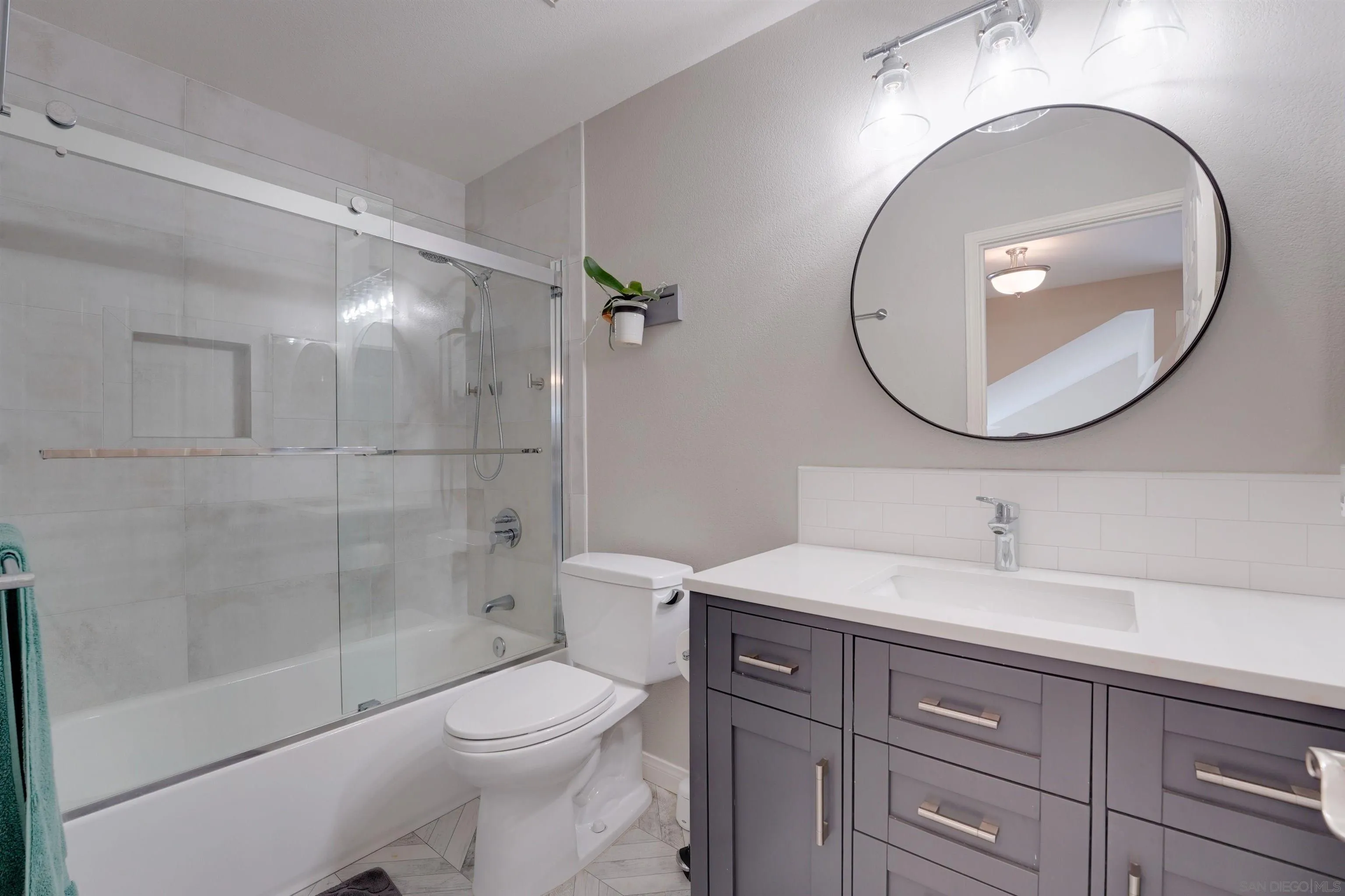 1647 Hawk View Drive Encinitas, CA 92024 - Photo 25 of 73 a bathroom with a sink a toilet and a mirror