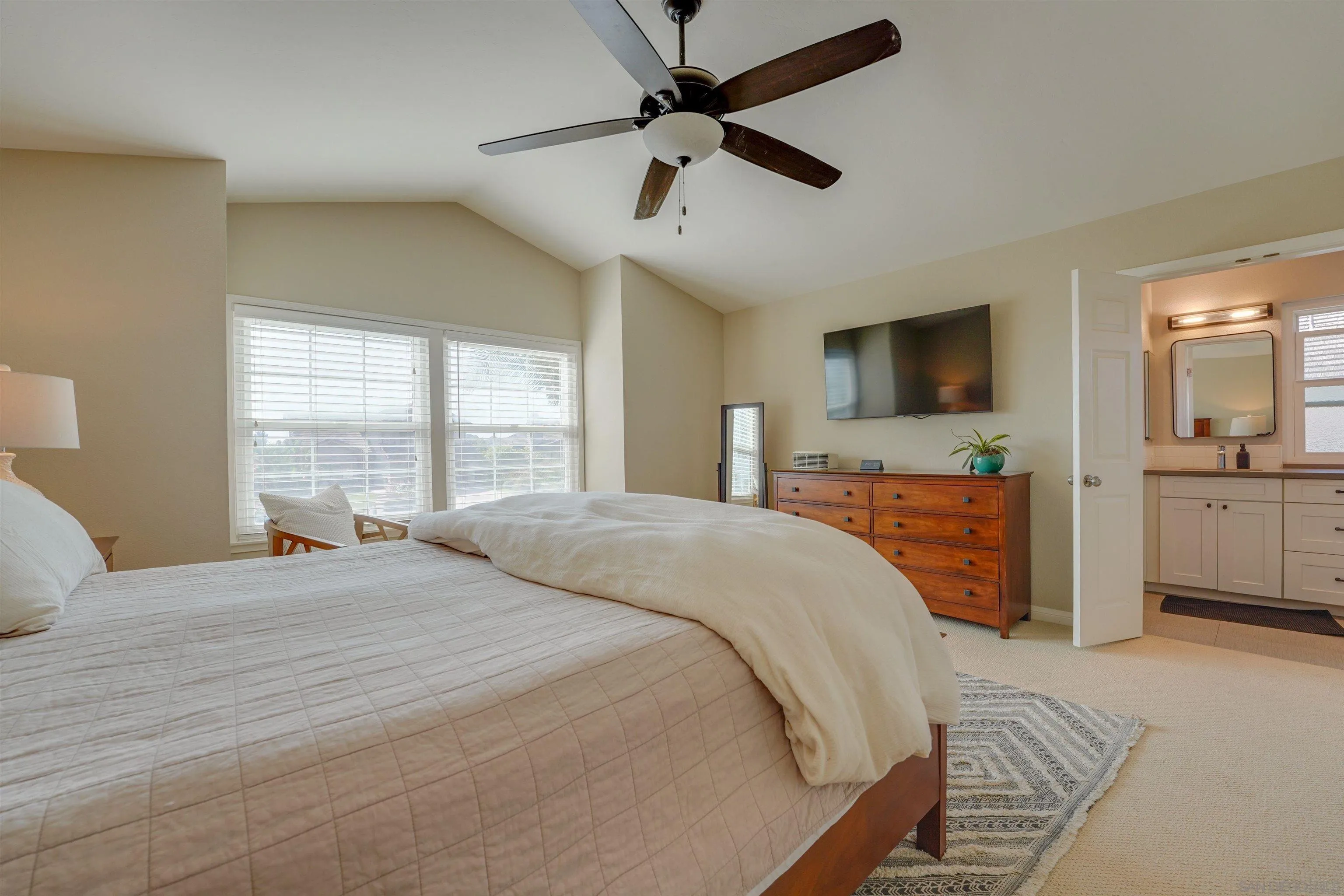 1647 Hawk View Drive Encinitas, CA 92024 - Photo 37 of 73 a bedroom with a bed and a flat screen tv