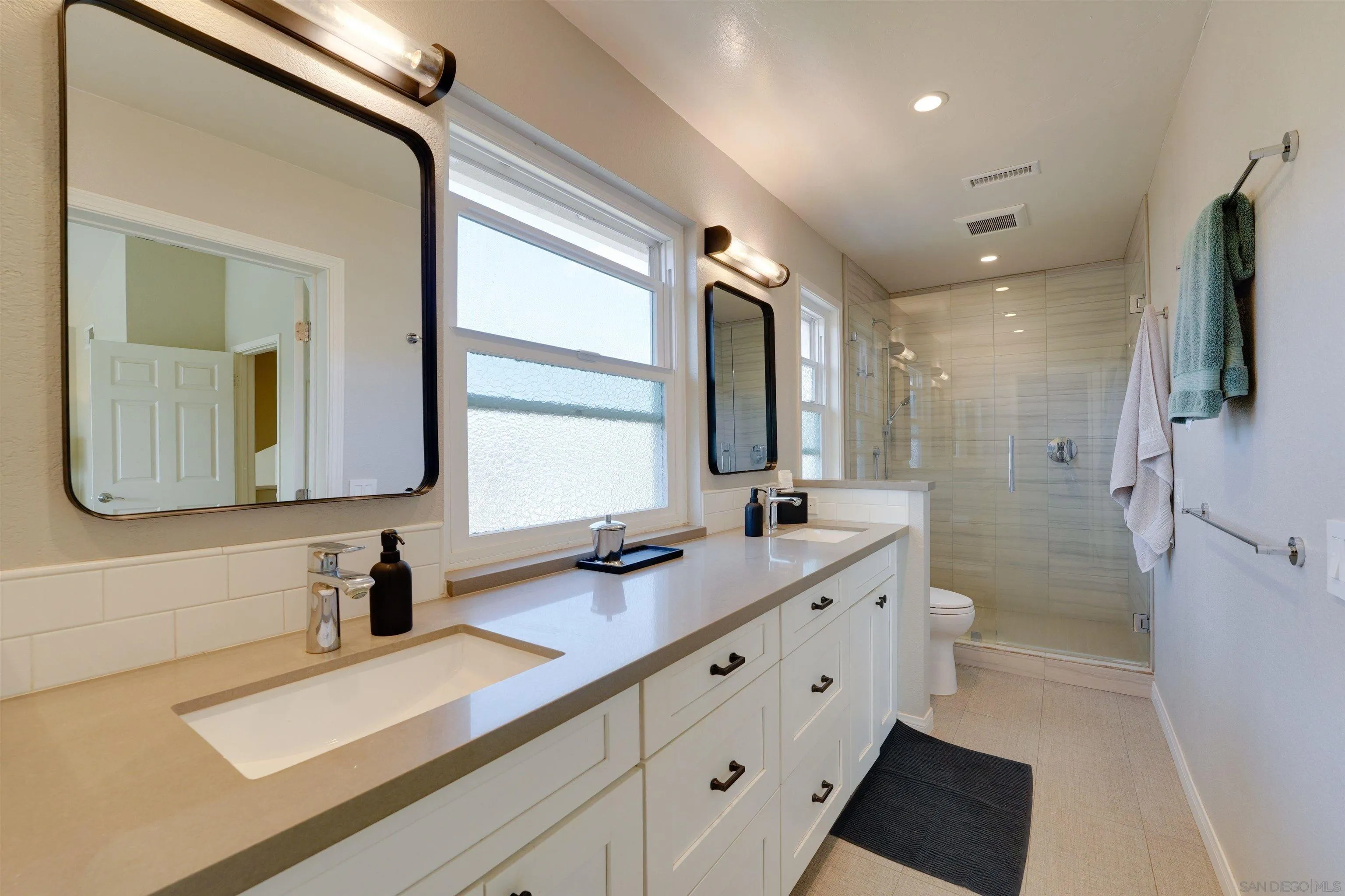 1647 Hawk View Drive Encinitas, CA 92024 - Photo 41 of 73 a bathroom with a double vanity sink mirror and double