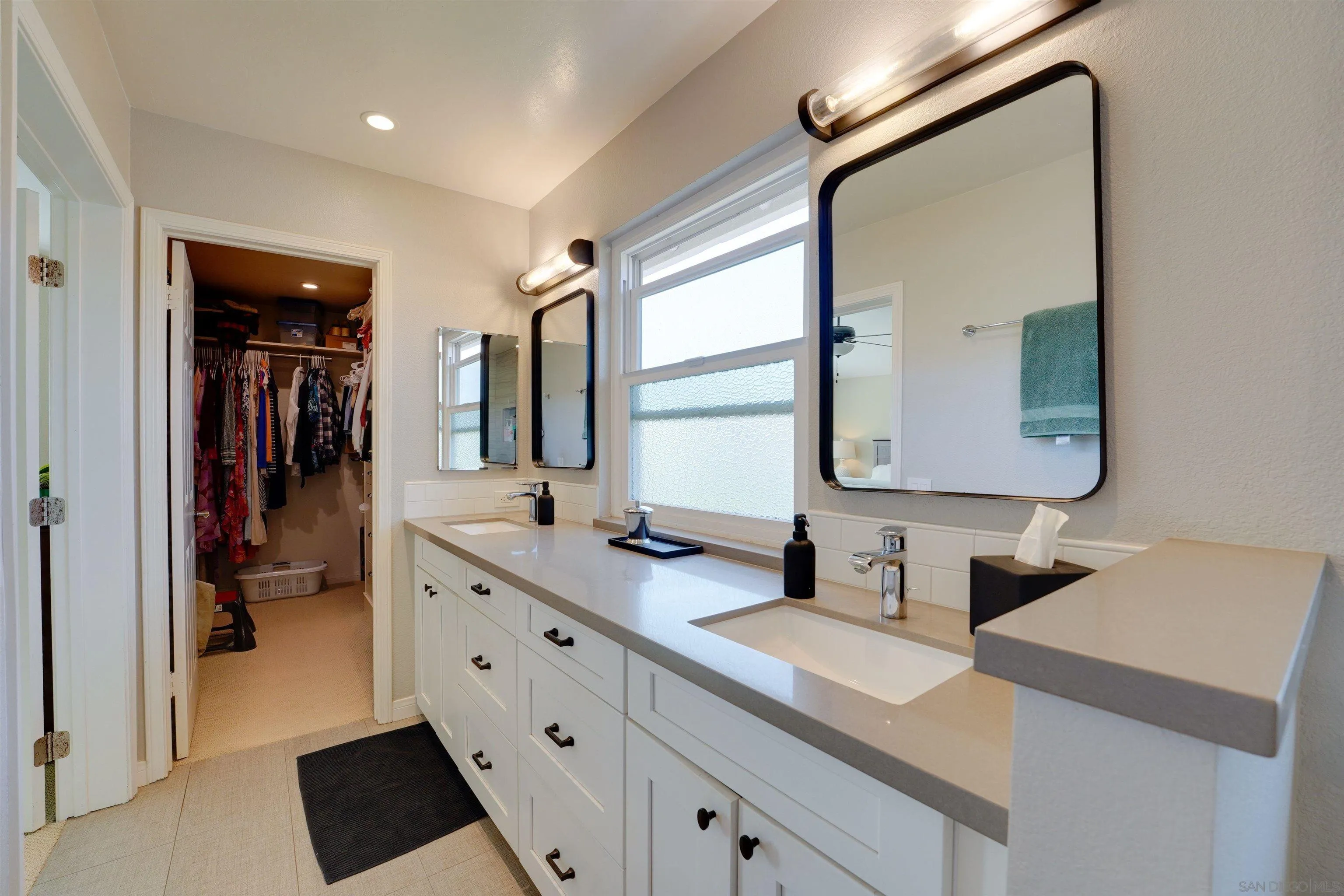 1647 Hawk View Drive Encinitas, CA 92024 - Photo 42 of 73 a en suite bathroom with a double vanity sink and a mirror