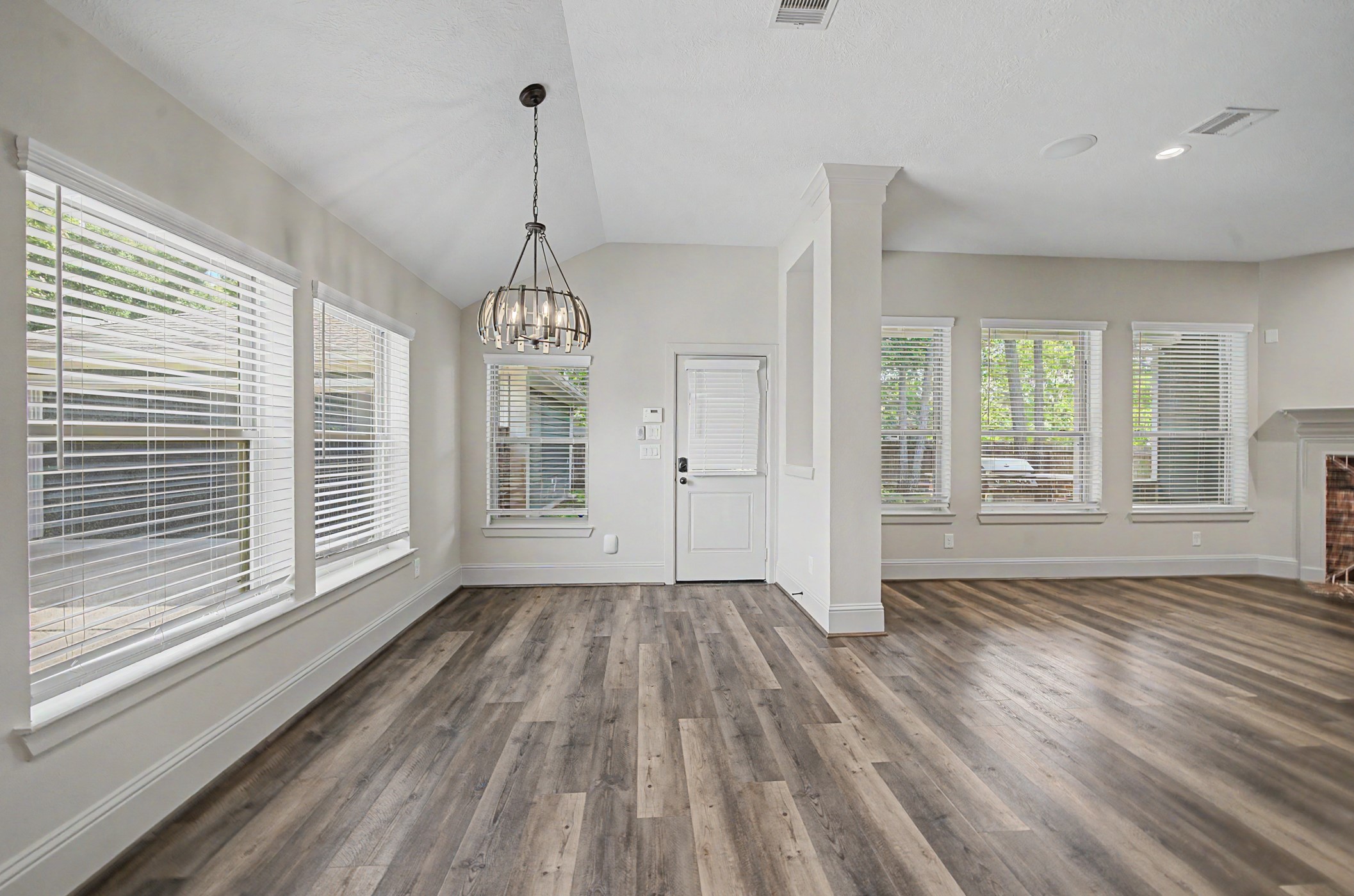 31032 Sunfall Trail Lane Spring, TX 77386 - Photo 12 of 39 a view of an empty room with wooden floor and a window