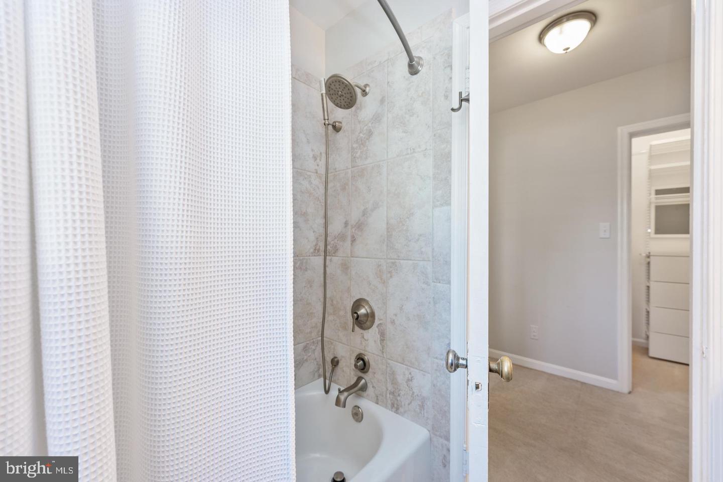 1902 North Rhodes Street, Unit 66 Arlington, VA 22201 - Photo 16 of 28 a bathroom with a bathtub and a shower