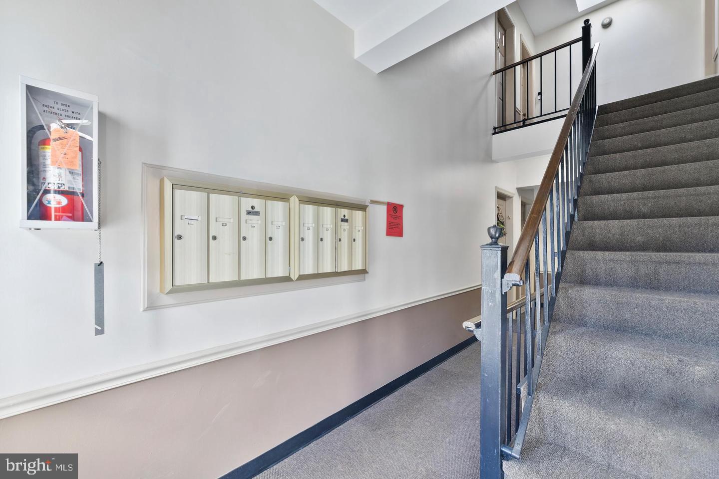 1902 North Rhodes Street, Unit 66 Arlington, VA 22201 - Photo 20 of 28 a view of staircase with lots of frames on wall and a window