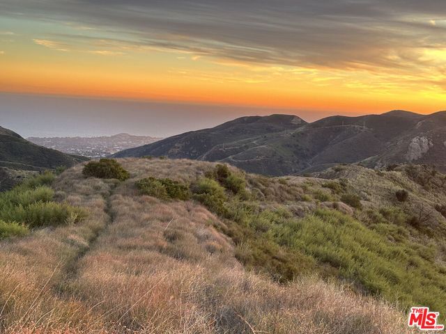 a view of an ocean and a mountain