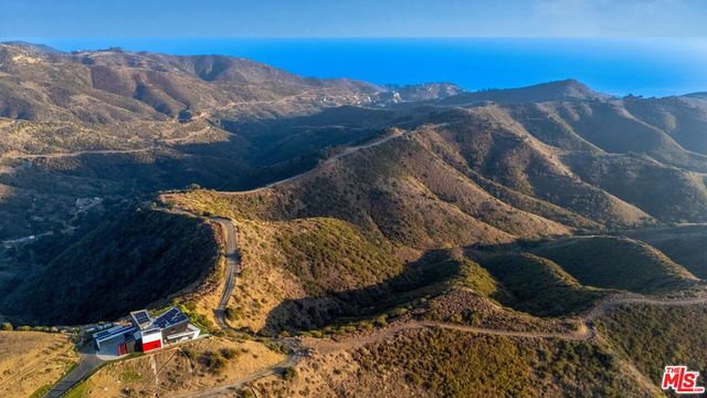 a view of mountain and an ocean