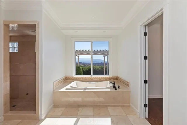 a spacious bathroom with bathtub and shower