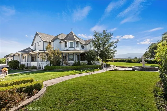 a front view of a house with a yard table and chairs