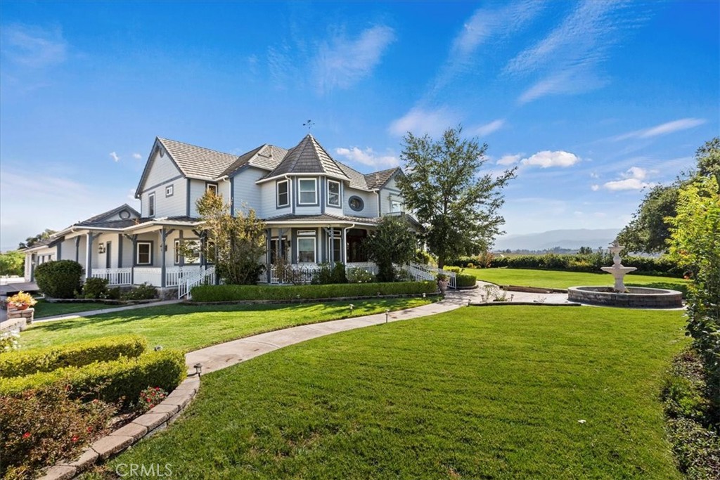 39650 Patagonia Court Temecula, CA 92591 - Photo 3 of 55 a front view of a house with a yard table and chairs