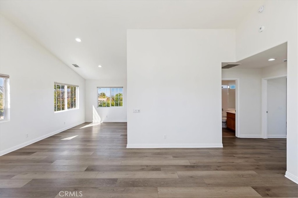 39650 Patagonia Court Temecula, CA 92591 - Photo 40 of 55 a view of an empty room with wooden floor and a window