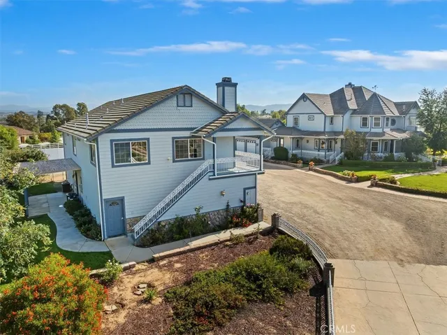 an aerial view of a house with a yard and lake view