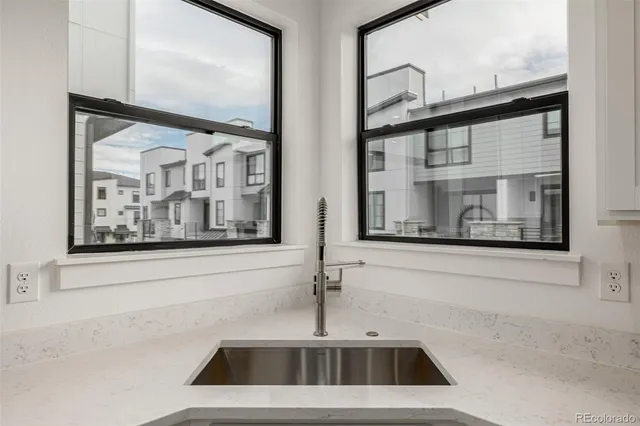 a view of a sink and a mirror of a room