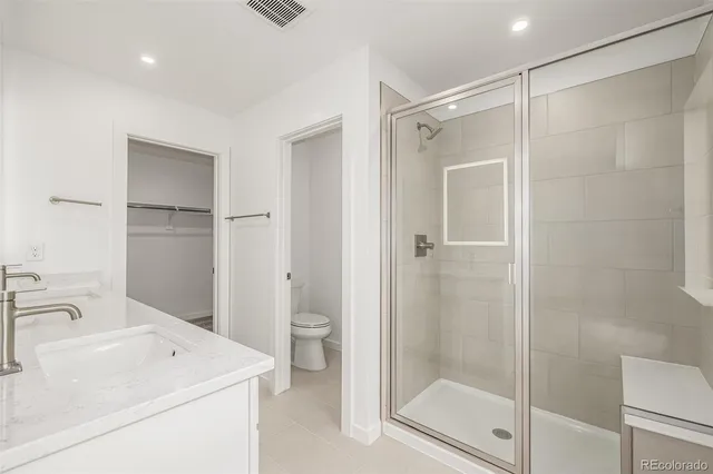 a bathroom with double vanity sink and a mirror