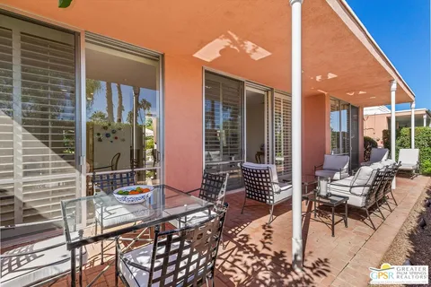 a backyard of a house with outdoor seating