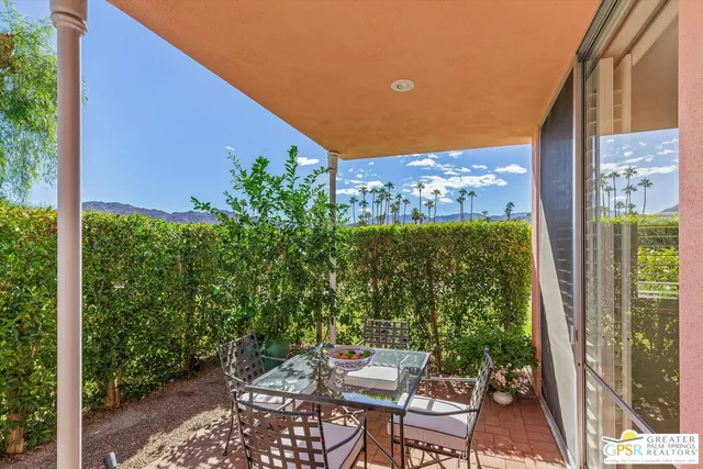 a view of a patio with table and chairs and potted plants