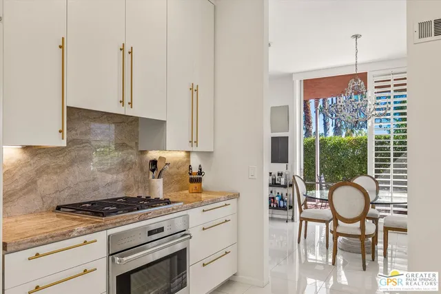 a kitchen with granite countertop a sink and a window