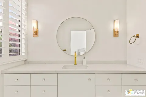 a bedroom with bed and a large window