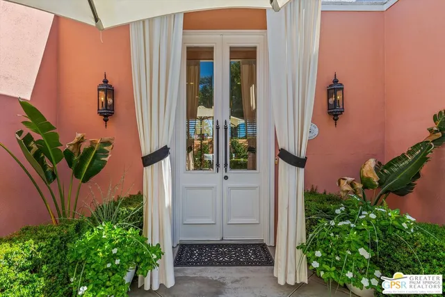 a view of patio with chairs and table under an umbrella