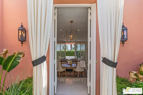 a living room with furniture flat screen tv and a large window