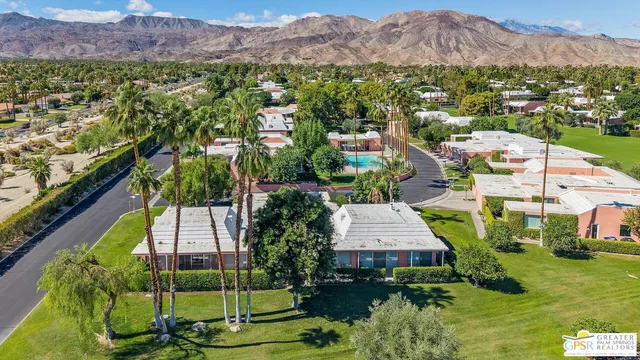 an aerial view of residential house and sandy dunes