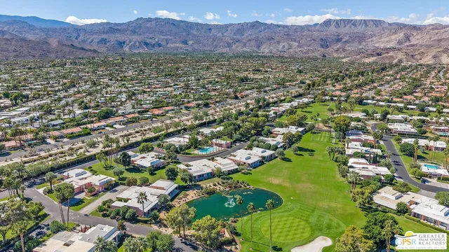 a living room with patio furniture and a garden