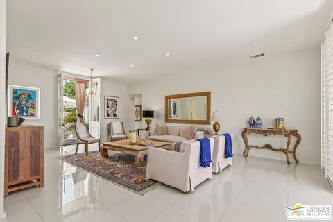 a living room with fireplace furniture and a table
