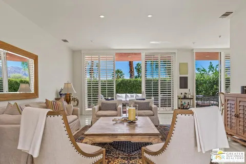 a living room with furniture a rug and a large window