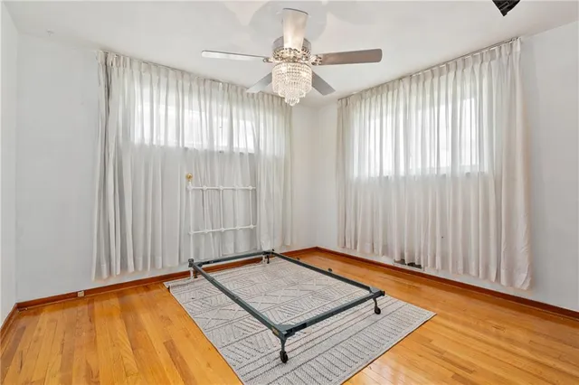a view of a room with wooden floor and windows