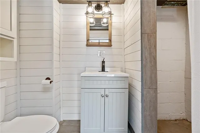 a bathroom with a toilet a sink and mirror