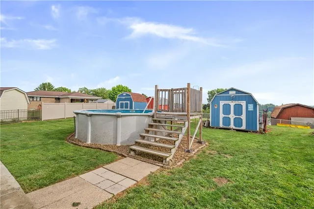 a view of a house with a yard and sitting area