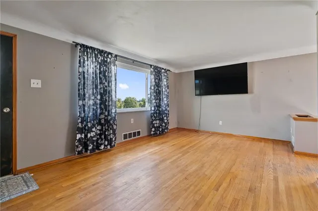 a view of livingroom with hardwood floor and a ceiling fan