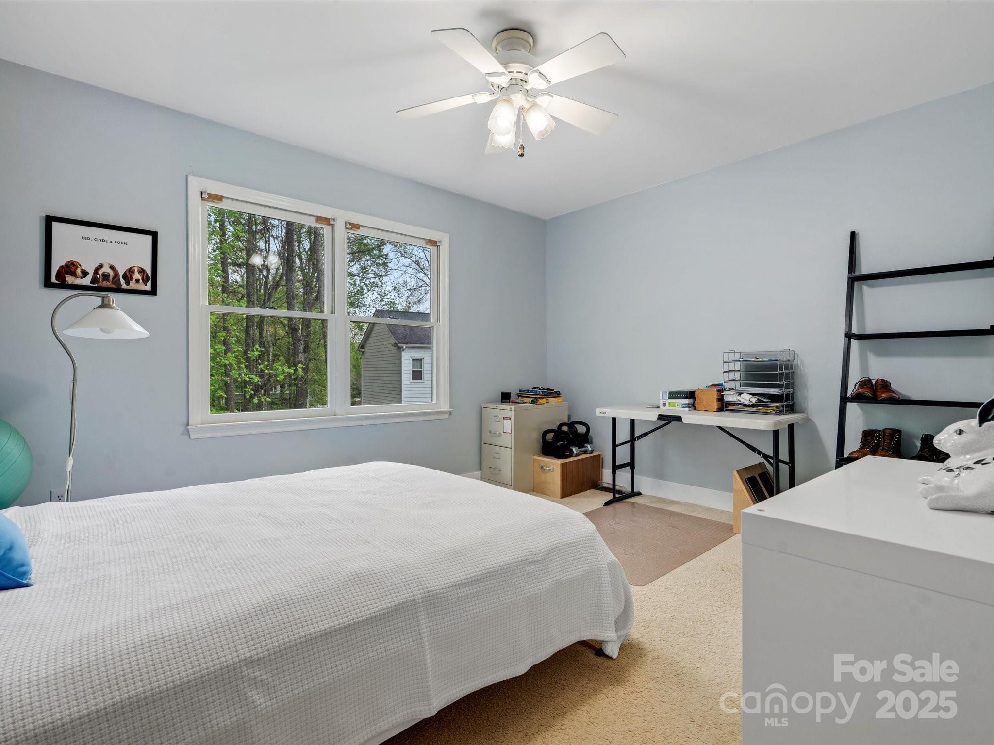 2812 Edgebrook Circle Matthews, NC 28105 - Photo 30 of 46 a bedroom with a bed a large window and potted plant on a dresser