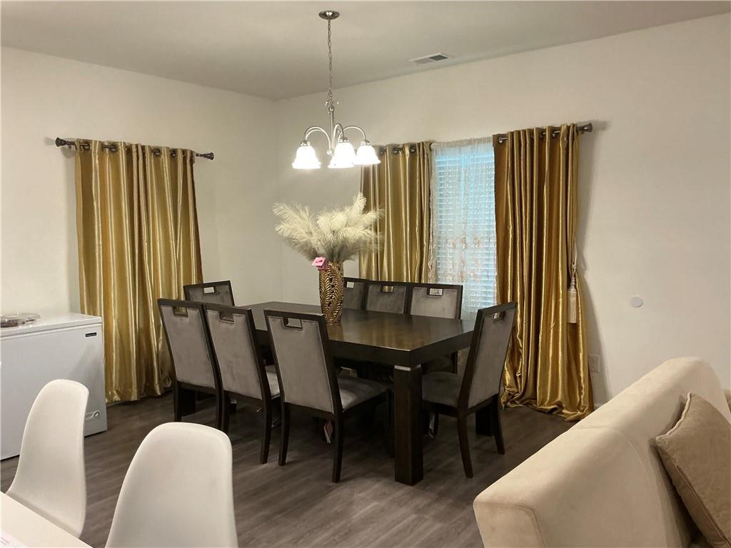 860 North Bethany Road McDonough, GA 30252 - Photo 13 of 57 a view of a dining room with furniture and wooden floor