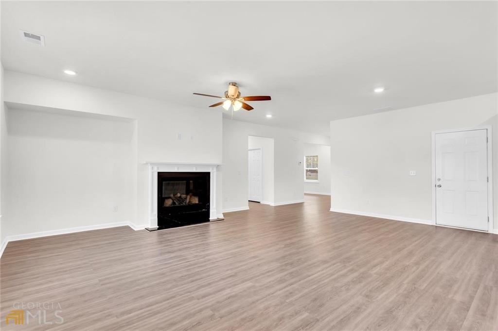 860 North Bethany Road McDonough, GA 30252 - Photo 21 of 57 a view of an empty room with wooden floor and a fireplace