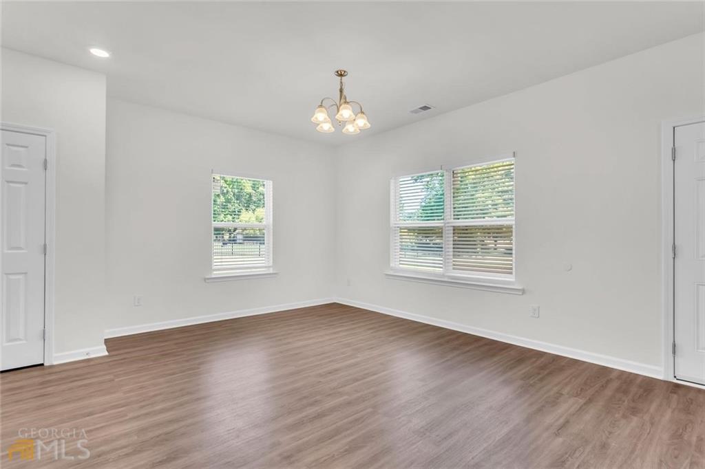 860 North Bethany Road McDonough, GA 30252 - Photo 24 of 57 a view of an empty room with wooden floor and a window