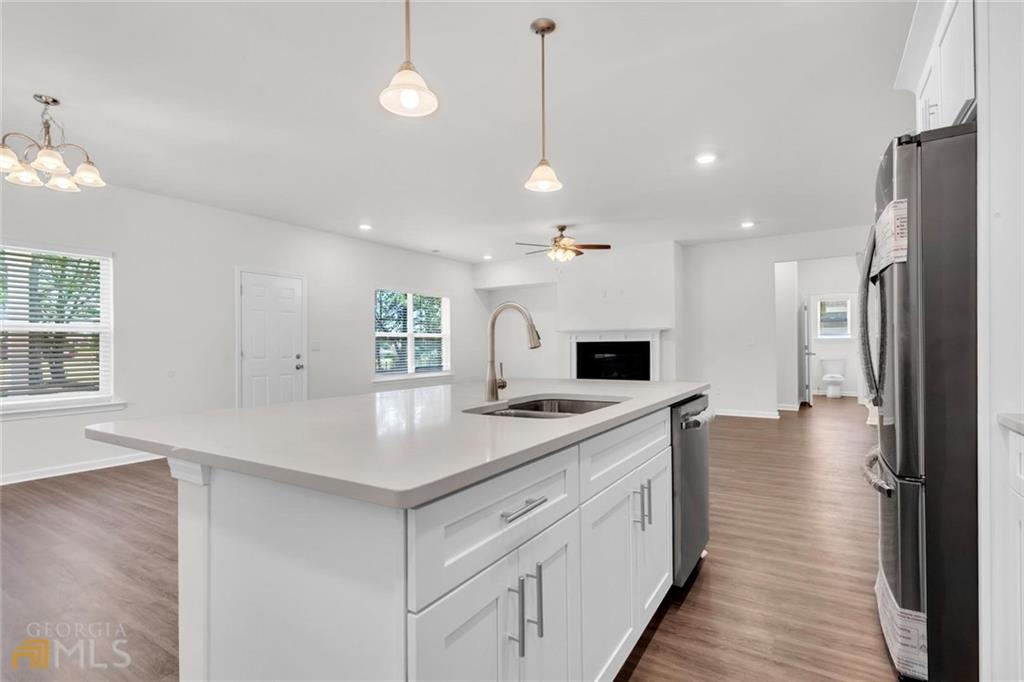 860 North Bethany Road McDonough, GA 30252 - Photo 29 of 57 a kitchen with a sink and a refrigerator