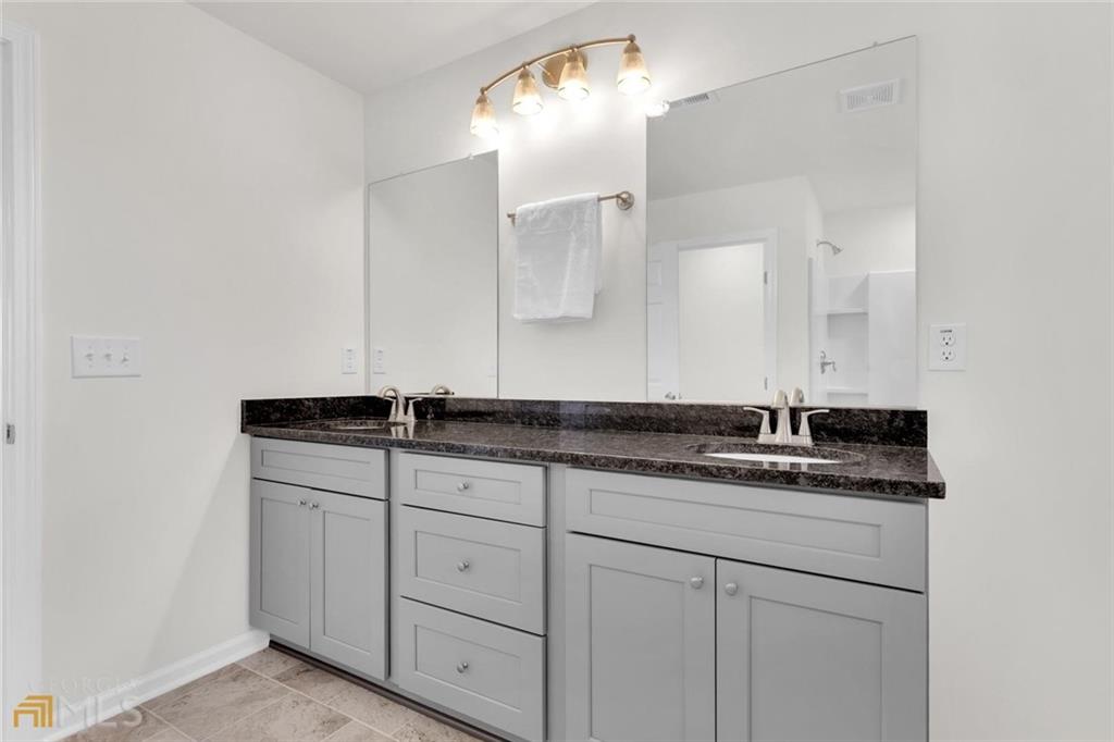860 North Bethany Road McDonough, GA 30252 - Photo 38 of 57 a bathroom with a sink and a mirror