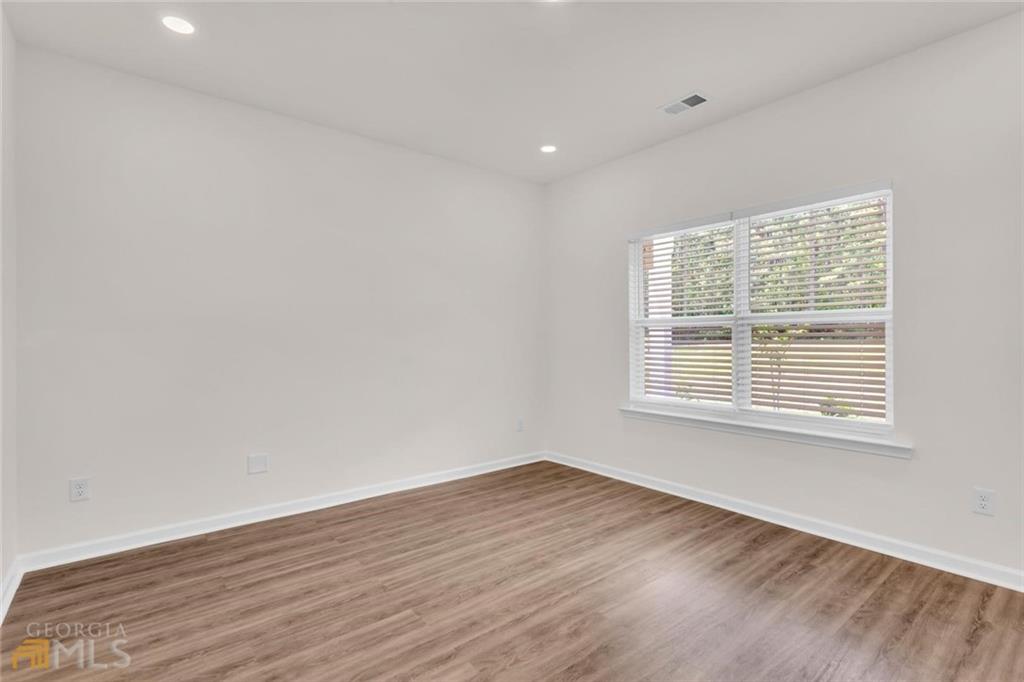 860 North Bethany Road McDonough, GA 30252 - Photo 48 of 57 a view of an empty room with wooden floor and a window
