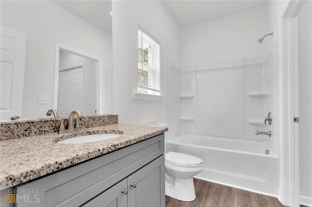860 North Bethany Road McDonough, GA 30252 - Photo 52 of 57 a bathroom with a granite countertop sink a toilet and bathtub