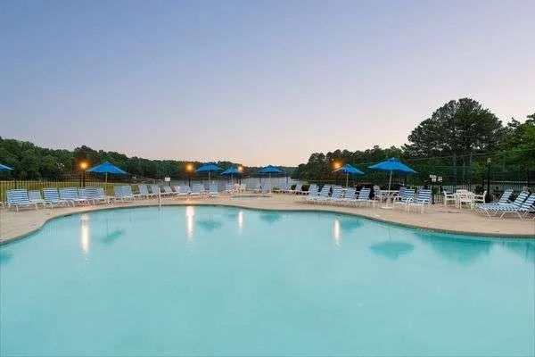 a view of a swimming pool and lounge chairs