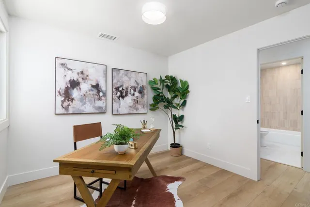 a patio with a table and chairs under an umbrella