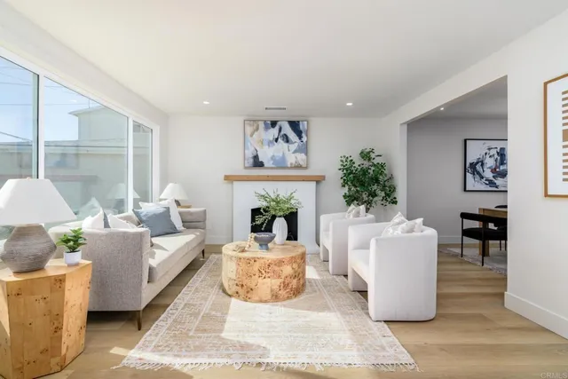 a living room with furniture a fireplace and a large mirror