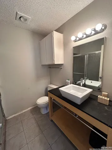 a bathroom with a sink a toilet and mirror