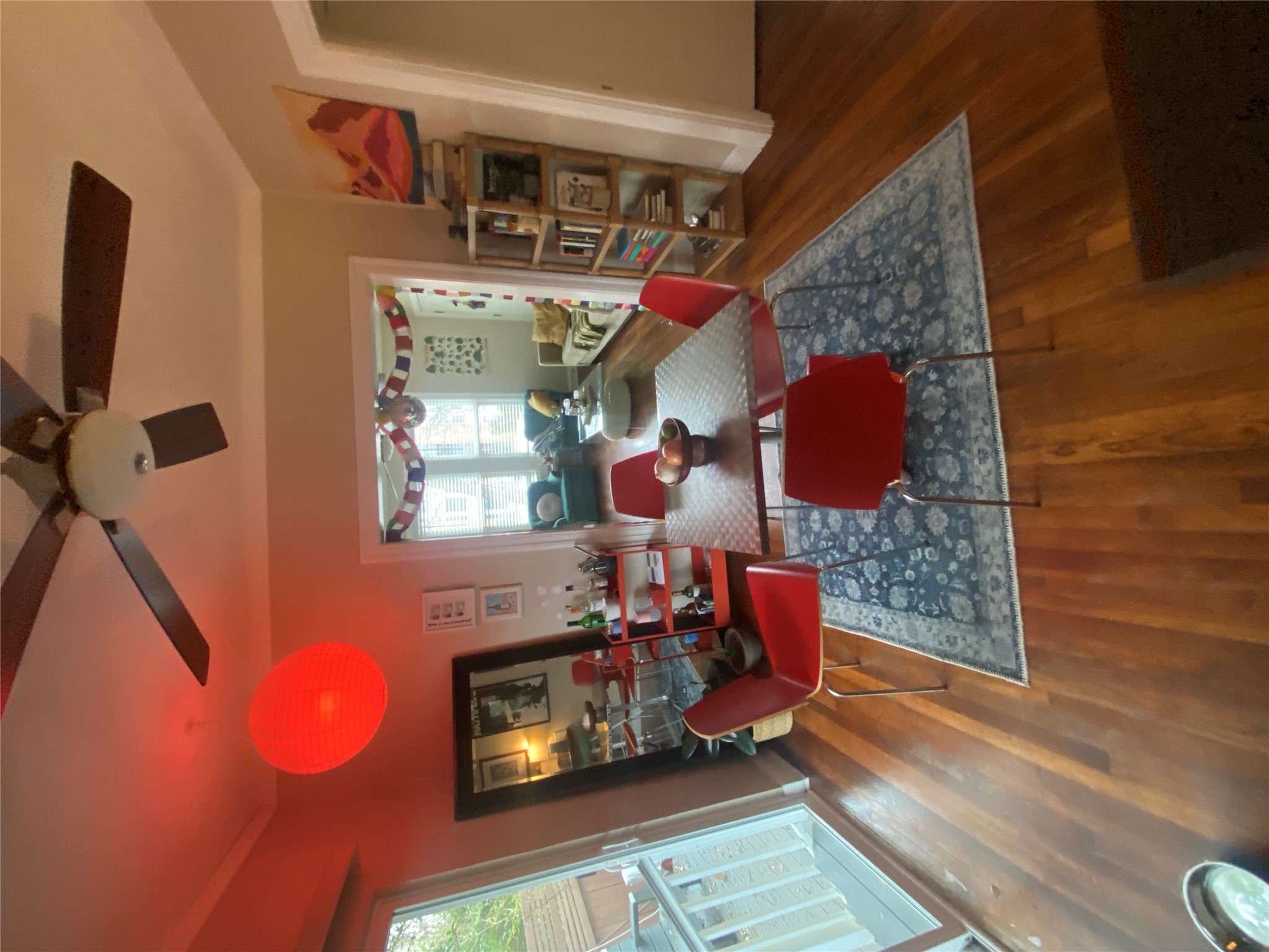 3010 Fruth Street, Unit A Austin, TX 78705 - Photo 10 of 39 Wood-finish flooring throughout, featuring a ceiling fan with integrated lighting, a sliding glass door, and crown molding