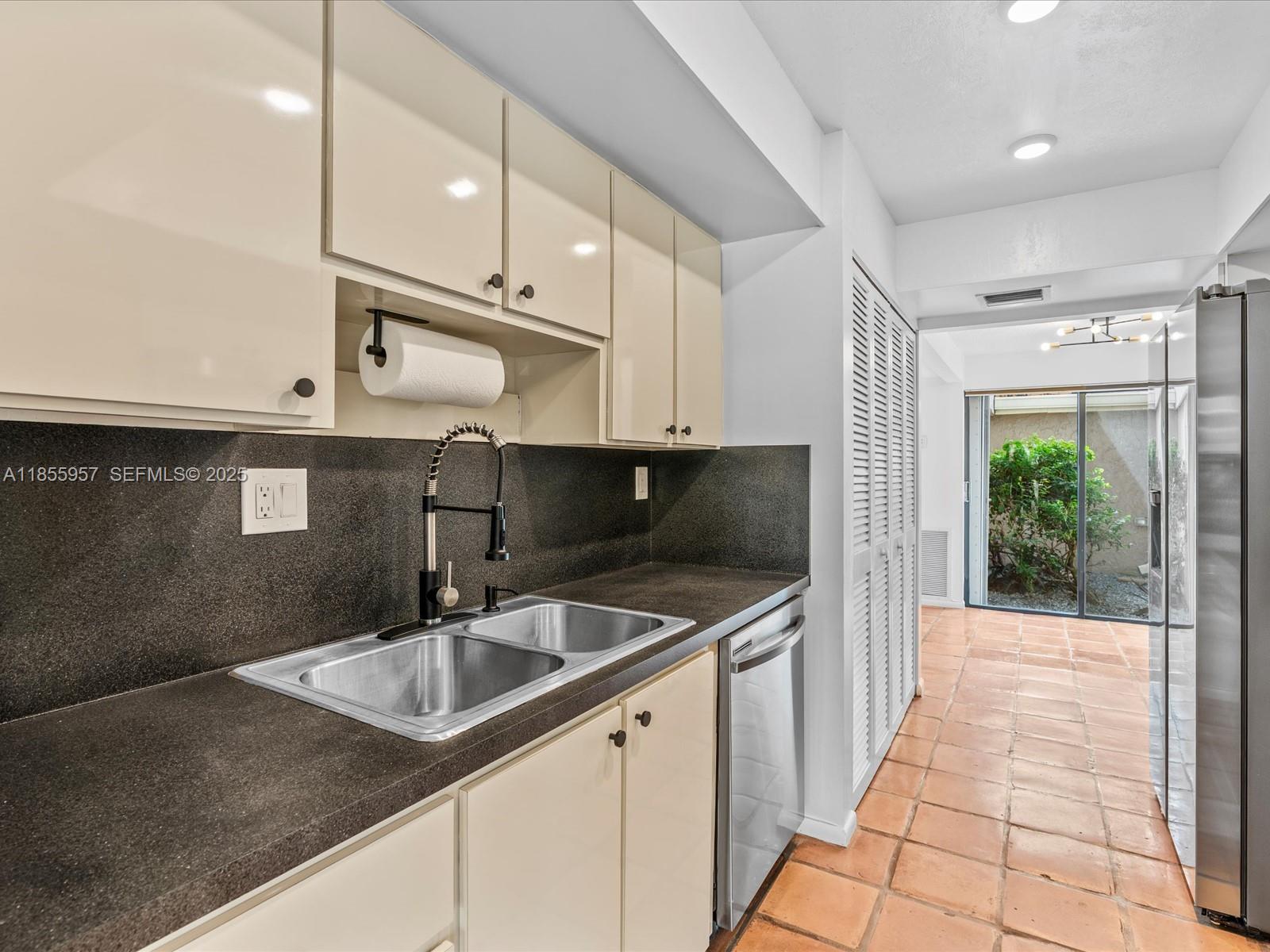 203 Bonnie Brae Way, Unit 34 Hollywood, FL 33021 - Photo 11 of 41 a kitchen with stainless steel appliances granite countertop a sink a stove and a wooden cabinets